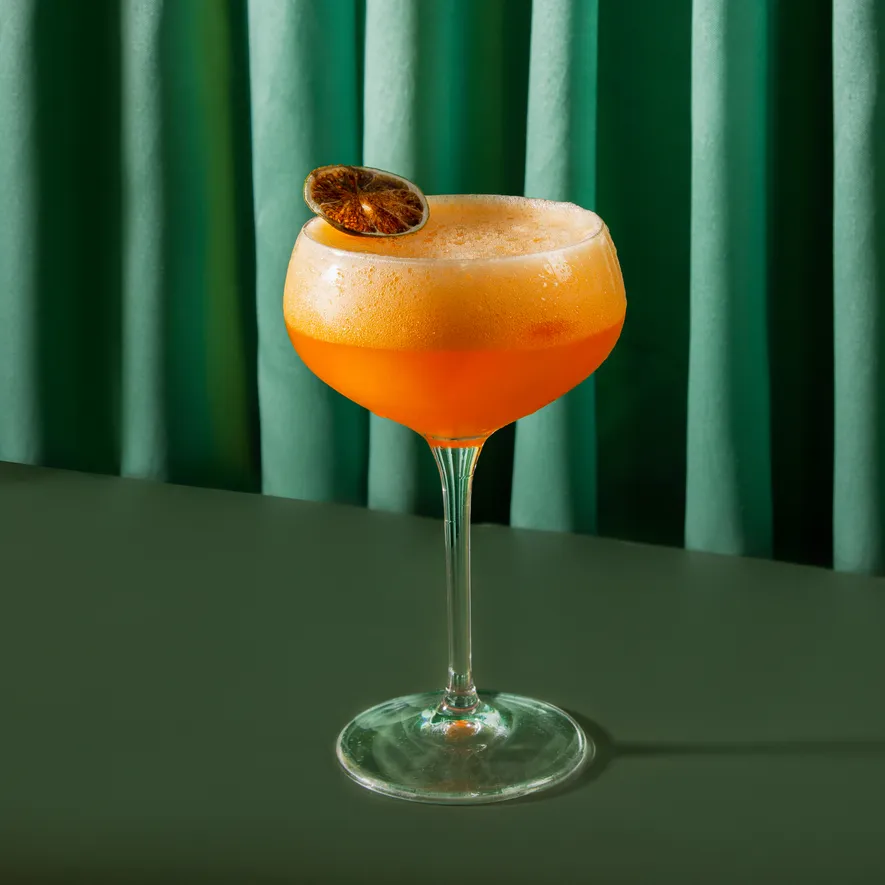 An orange sour in a coupe
